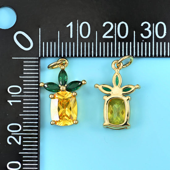 Emerald-cut lemon yellow zircon set as the fruit with green marquise-cut zircon leaves
