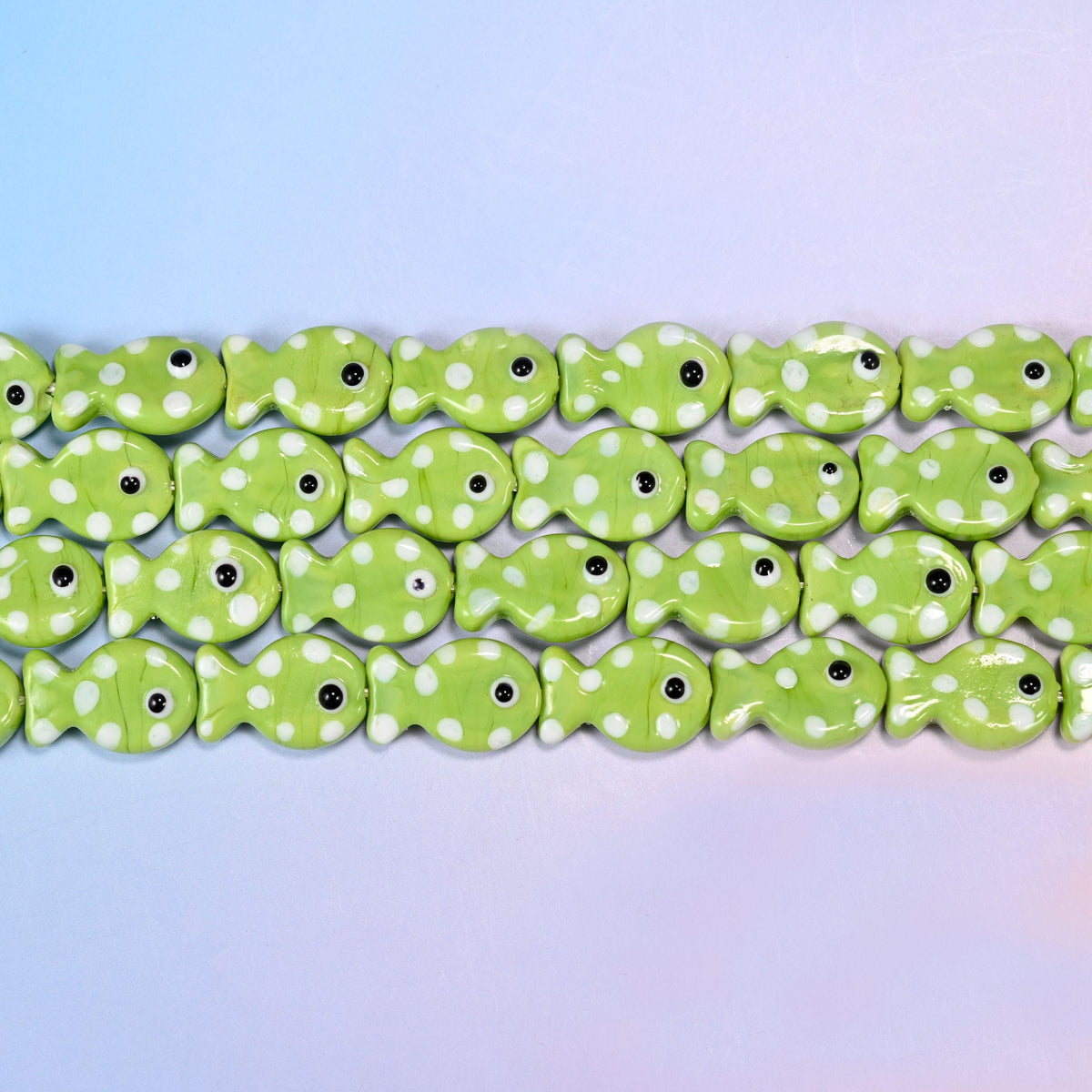 Fish glass beads in opaque apple-lime green with white dots