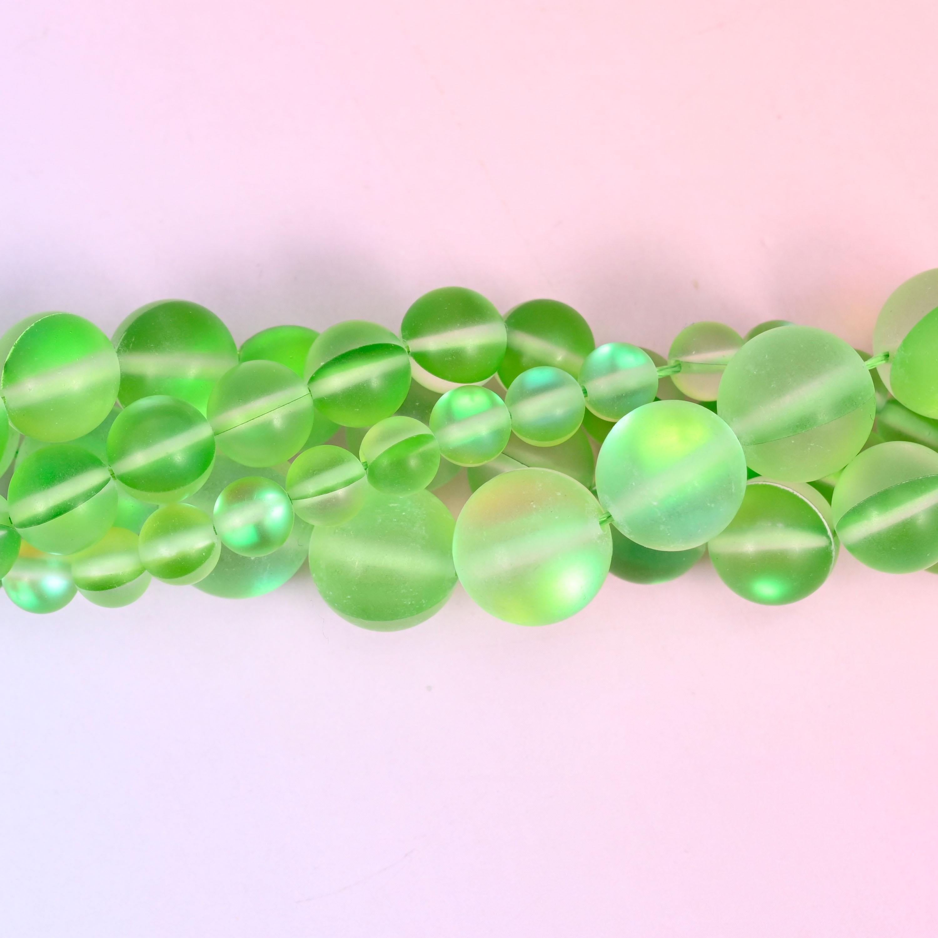 Bright apple green glass beads with a sanded frosted finish and aurora shimmer