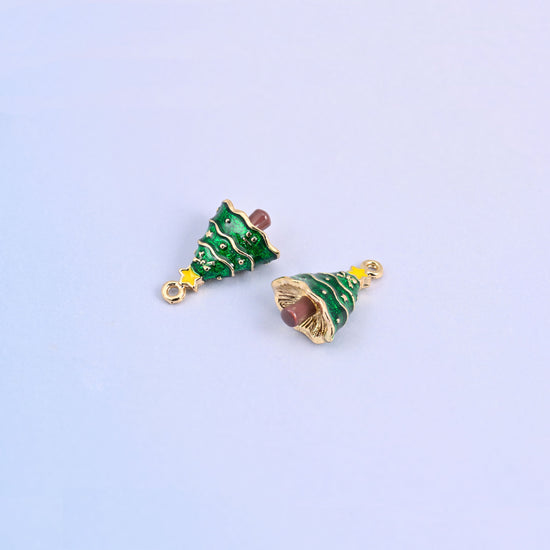 Two christmas tree charms angled to show the small gold ring at the top for easy attaching.