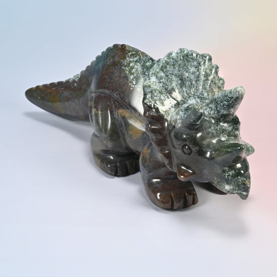 Close angle of the triceratops carving head and frill in natural green and brown Indian agate