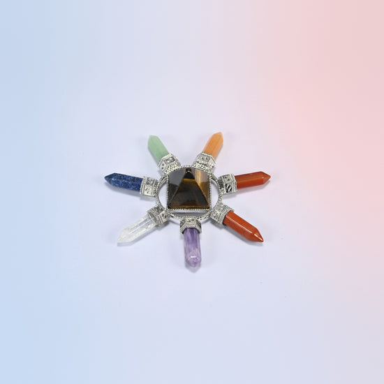 Crystal energy generator with a golden brown tiger eye pyramid and seven chakra crystal points in a silver-tone frame