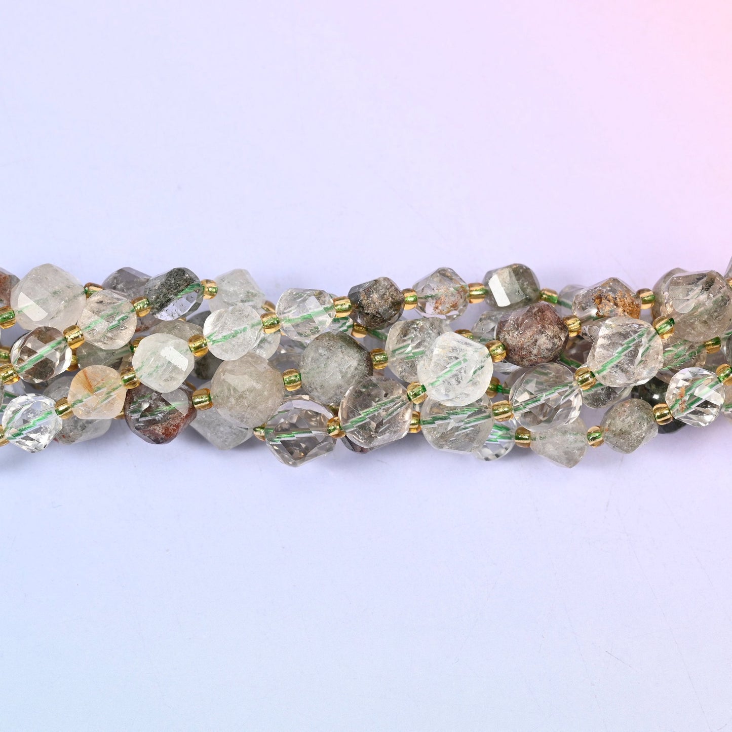 Green Phantom Quartz Faceted Spiral Twist Beads, clear to milky quartz with mossy green and rust-brown phantom inclusions