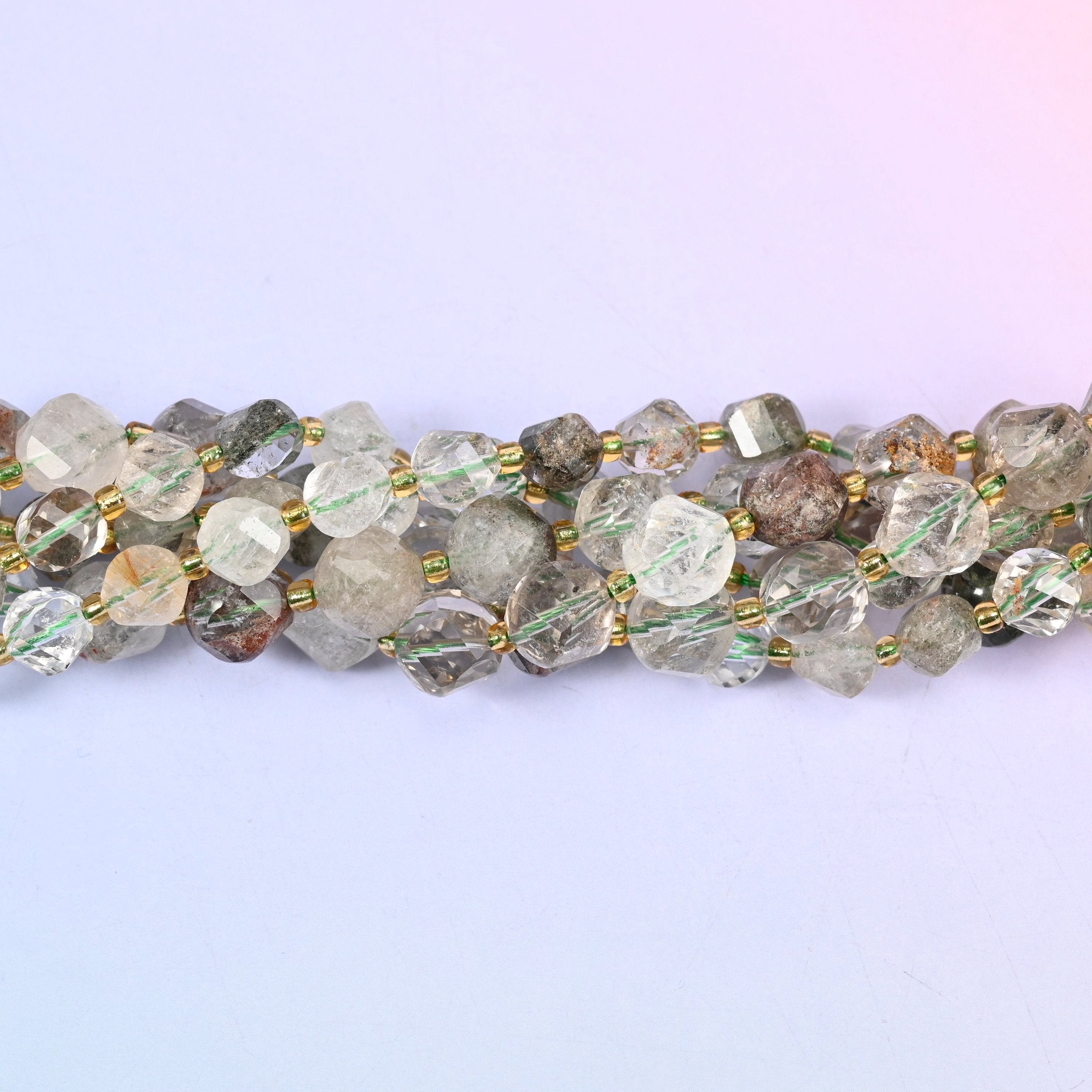 Green Phantom Quartz Faceted Spiral Twist Beads, clear to milky quartz with mossy green and rust-brown phantom inclusions