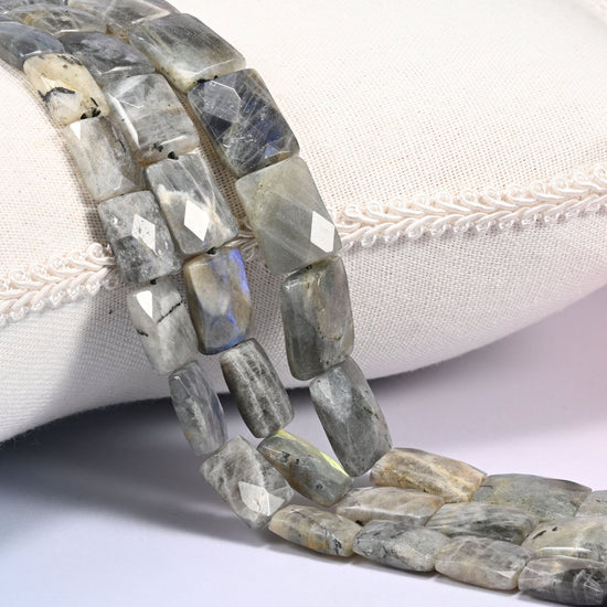 Gray Labradorite faceted flat rectangle beads draped in a soft curve, flat tablets in mid gray with white and tan streaking
