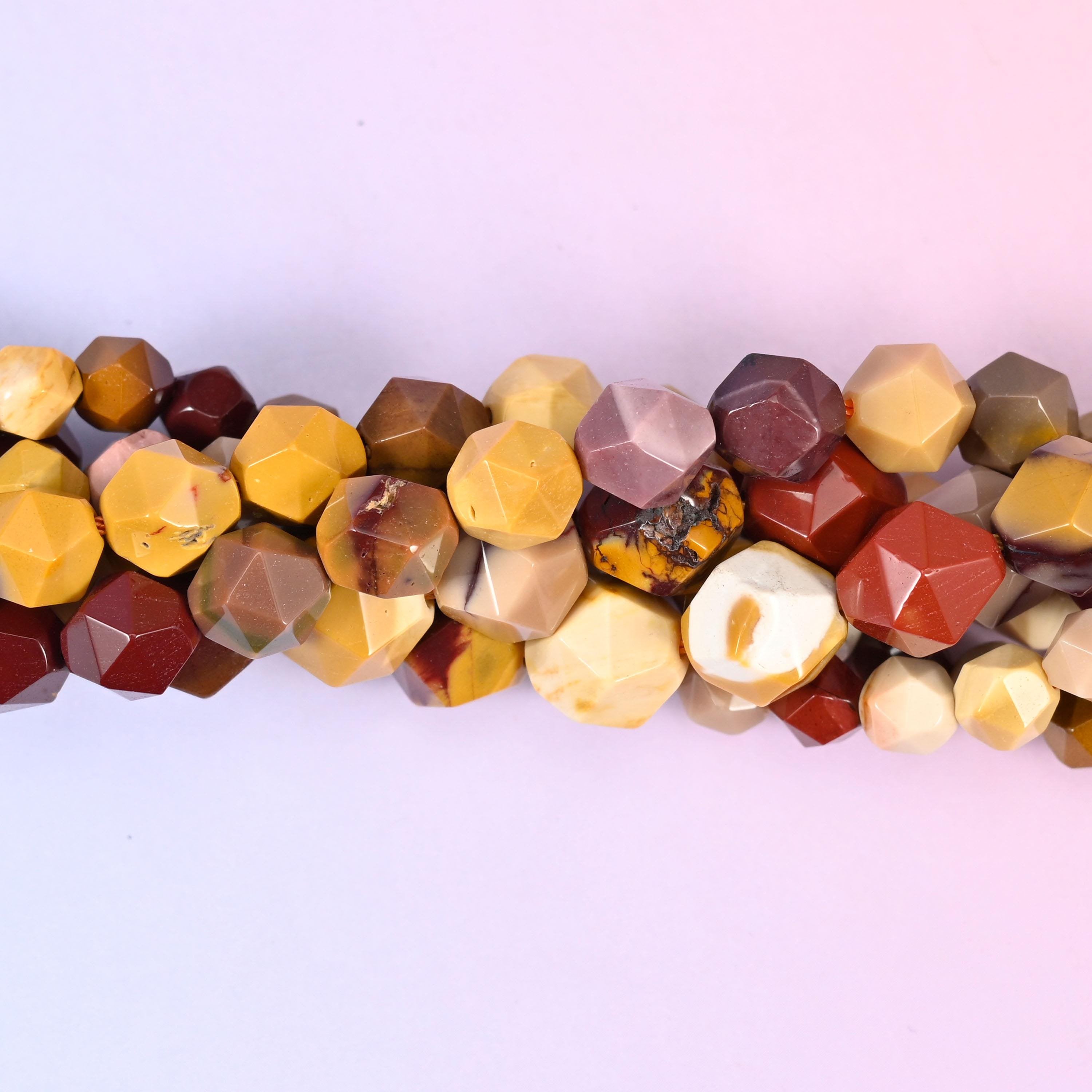 Natural Mookaite Jasper gemstone beads with a warm desert palette and faceted star cut