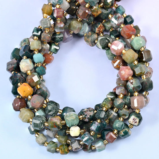 Sea green and teal shot through with dusty pink, cream, tan and rust, many beads carrying the little orbicular ring patterns ocean jasper is known for.