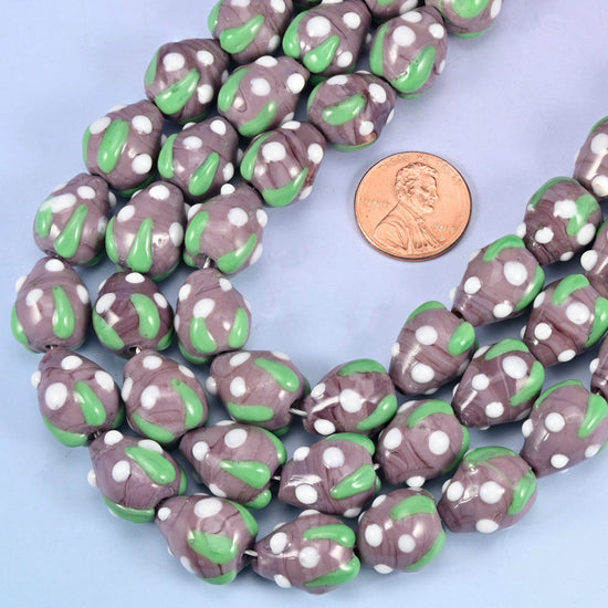 Strawberry shaped glass beads dotted all over in white