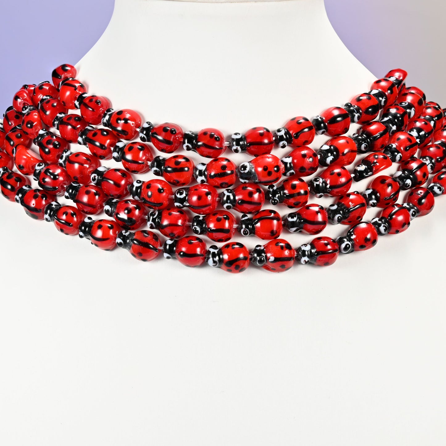Red ladybug glass beads, approximately 13.40x9.60mm.