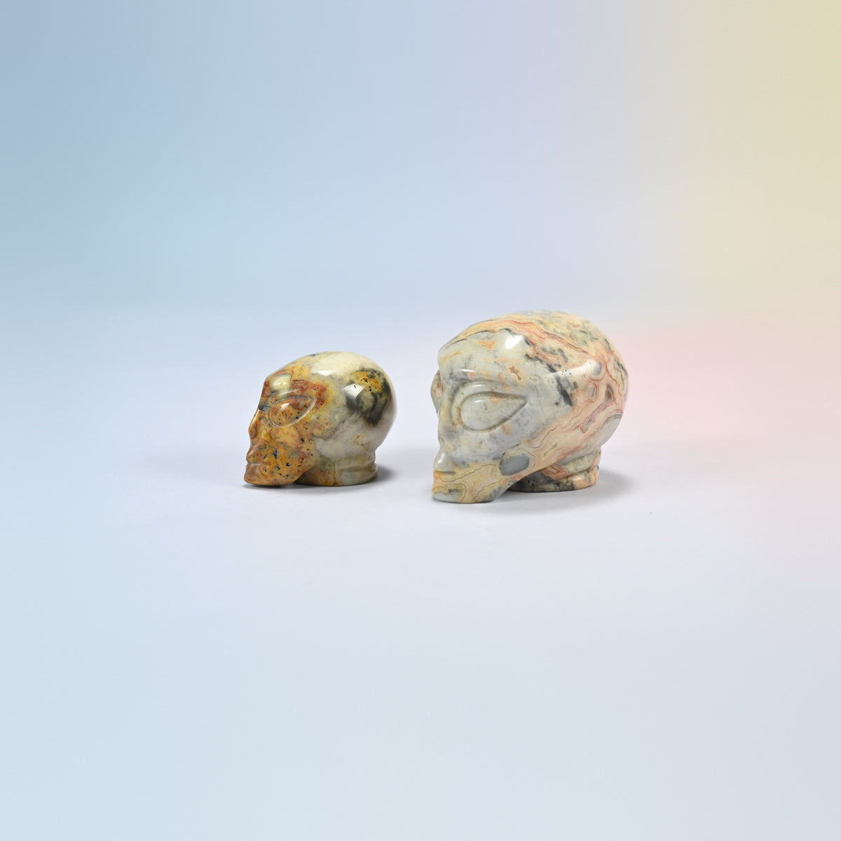 Two crazy agate alien head crystal carvings, 1.5 inch and 2 inch, cream, tan and peach natural stone