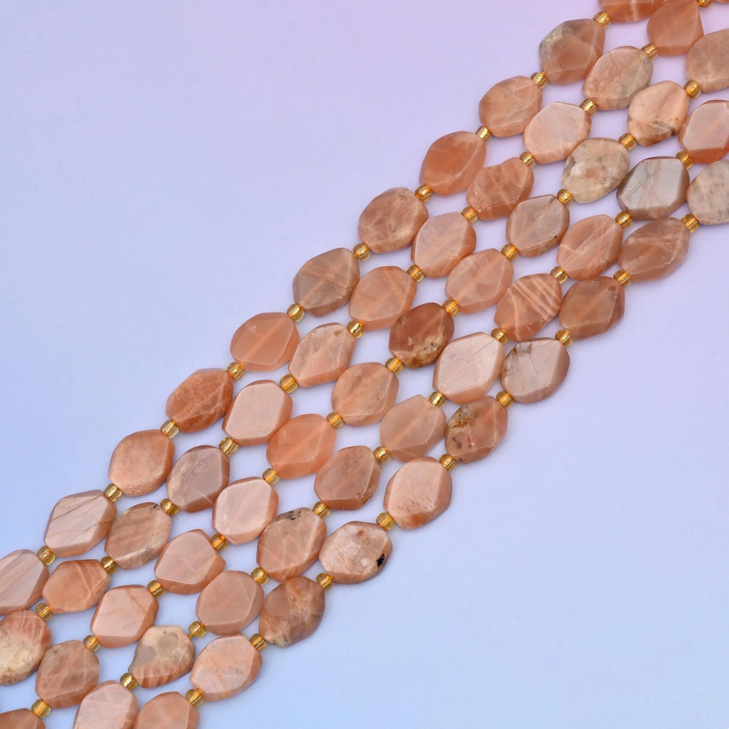 Sunstone beads in peach and apricot tones with pearly shimmer