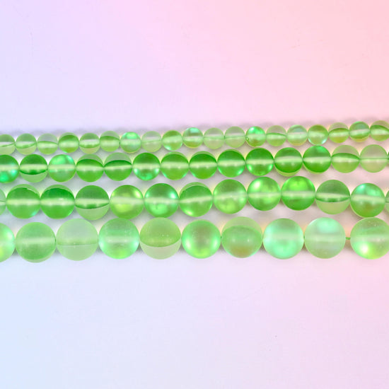 Matte glass beads in bright apple green with a pearly aurora shimmer