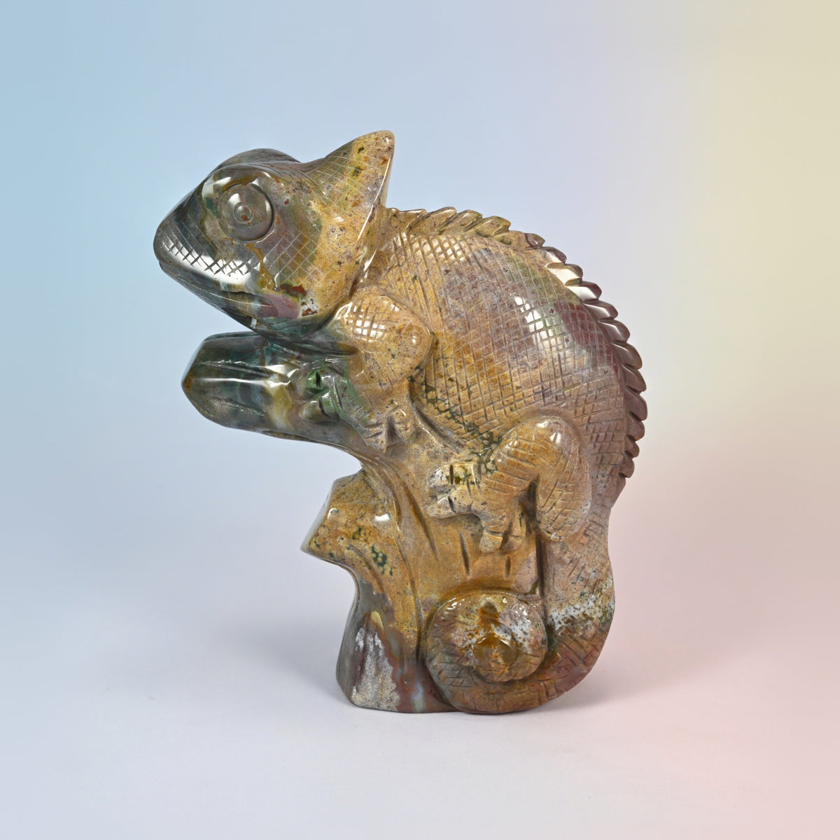 5.3 inch natural ocean jasper chameleon carving on a branch, curled tail, golden tan and olive green