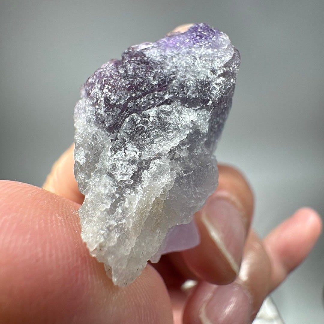 Bottom-up angle of the fluorite showing the rough natural break surface and layered colour zones