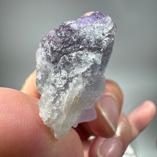 Bottom-up angle of the fluorite showing the rough natural break surface and layered colour zones
