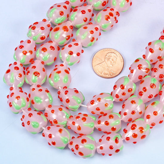 Strawberry shaped glass beads dotted with tiny raised red seeds