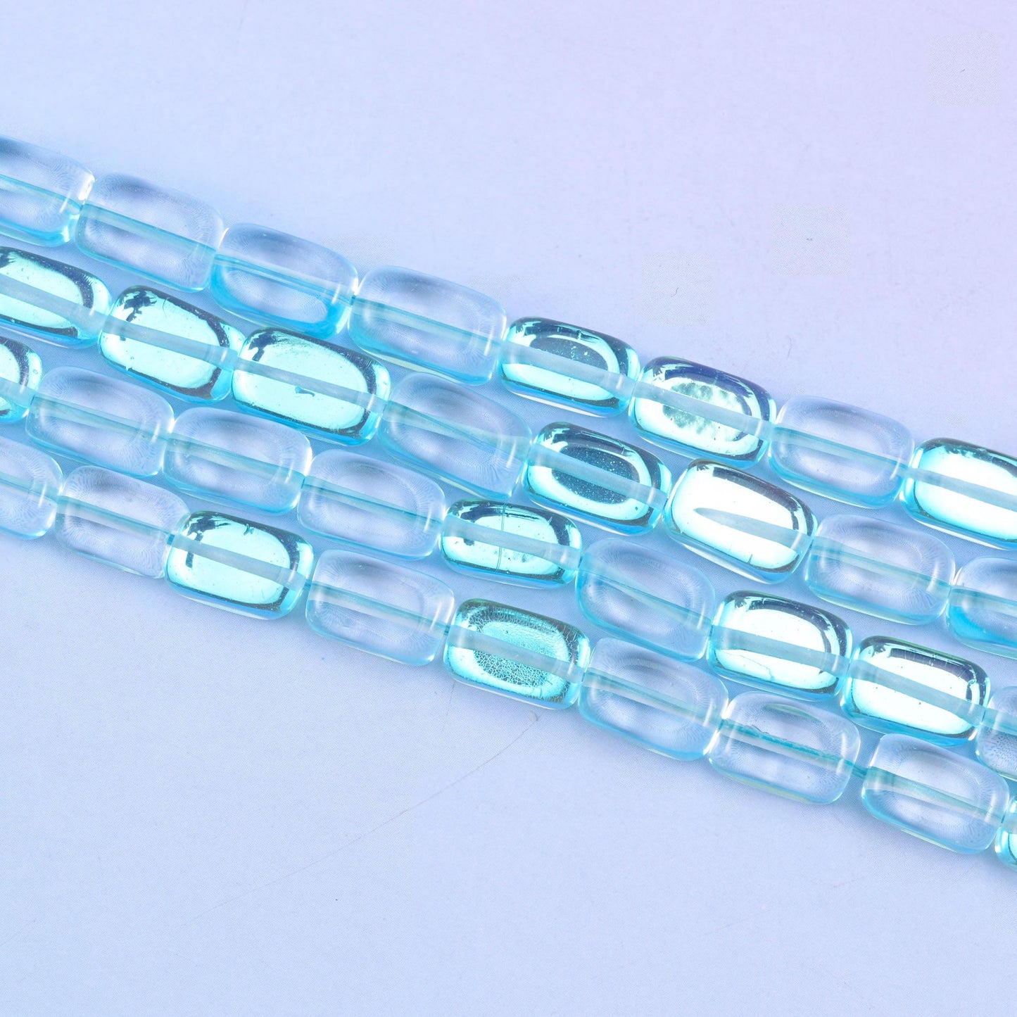 Light blue mystic aura beads in fresh aqua-blue with a subtle iridescent glow