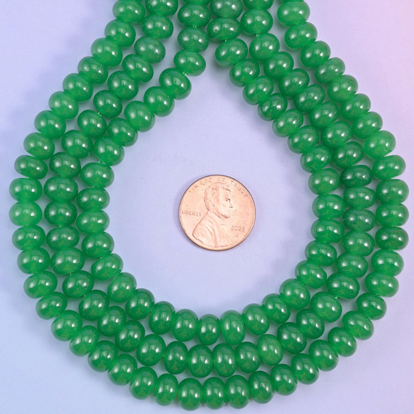 Green Dyed Jade smooth rondelle beads in a vivid emerald green, finished with a smooth, polished surface