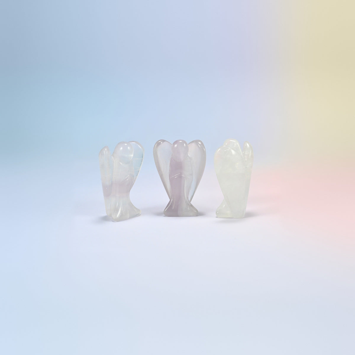 Three natural fluorite guardian angel carvings, clear to light lavender, 2 inch