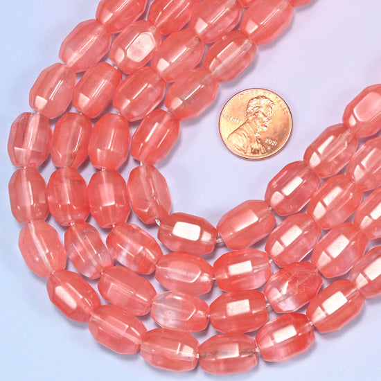 Wide circular coil of coral pink faceted glass barrel bead strands forming a full wreath shape on a light lavender and pink gradient background.