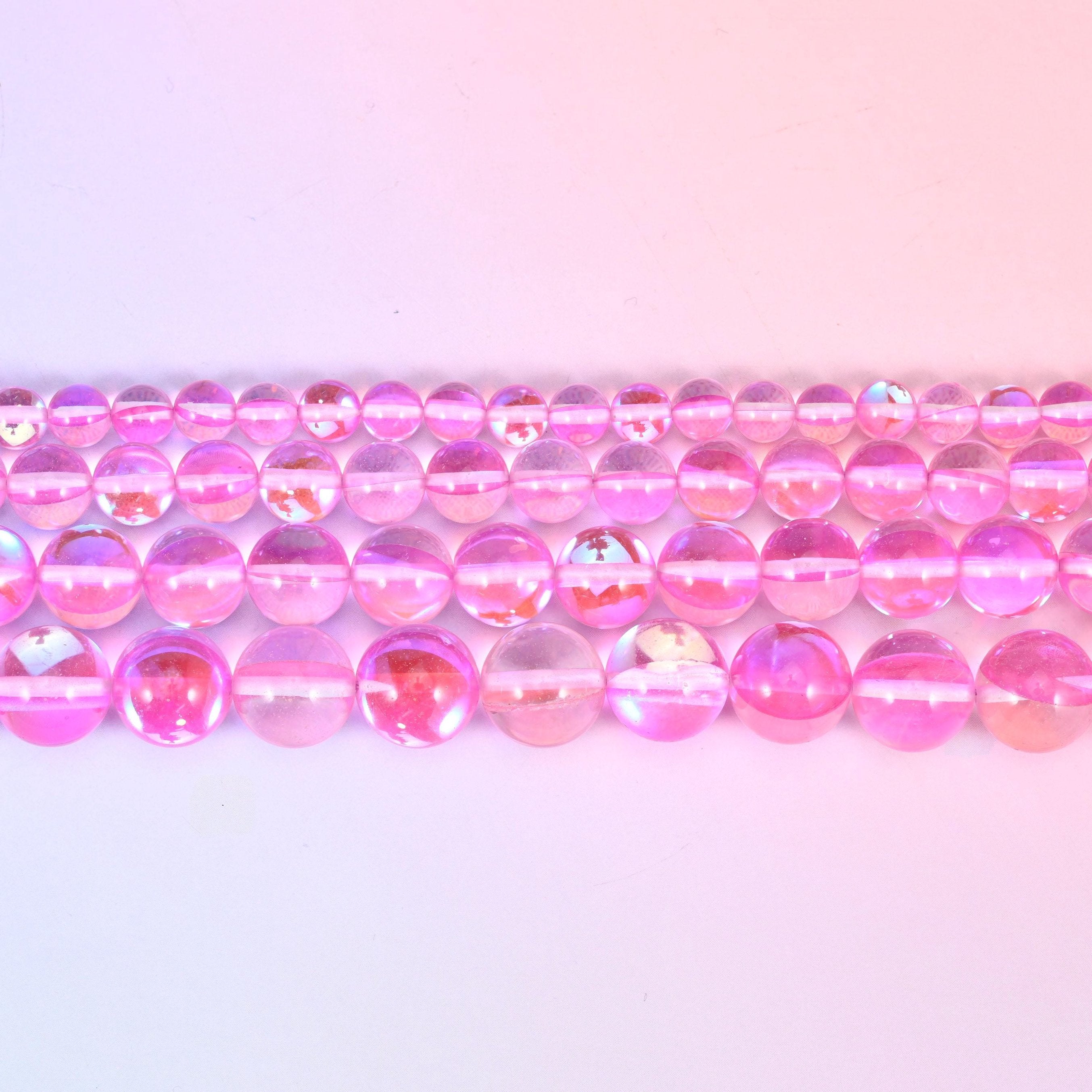 Mystic Aura beads in bubblegum-pink iridescent glass with lilac and gold shifts