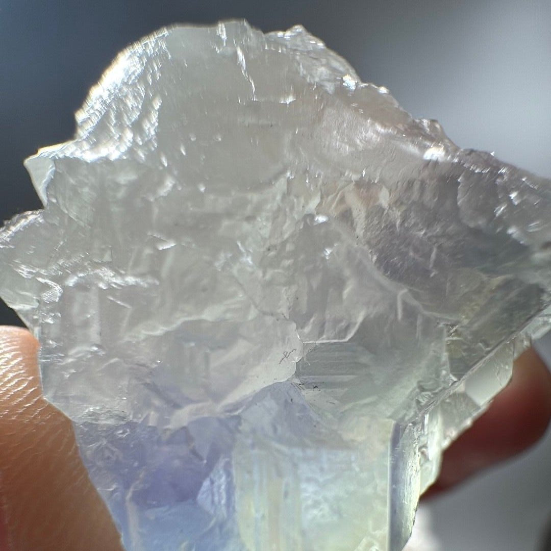 Macro of the fluorite crystal surface, sea-green faces over a blue-violet core