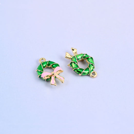 Green wreath charm next to a second turned over to show the plain gold plated back.