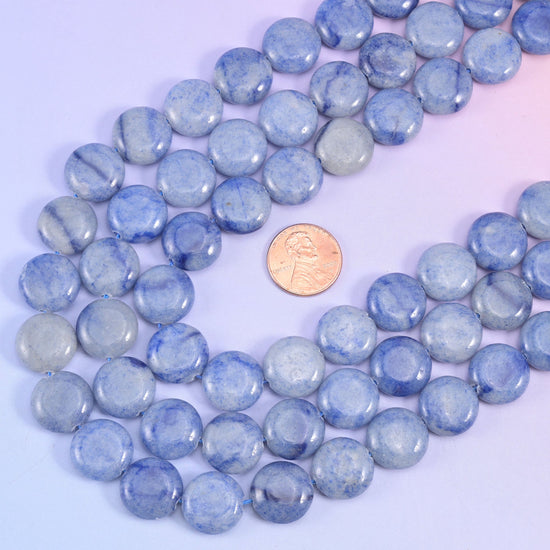 Blue aventurine coin strands looped around a US penny for size comparison with the 15mm beads
