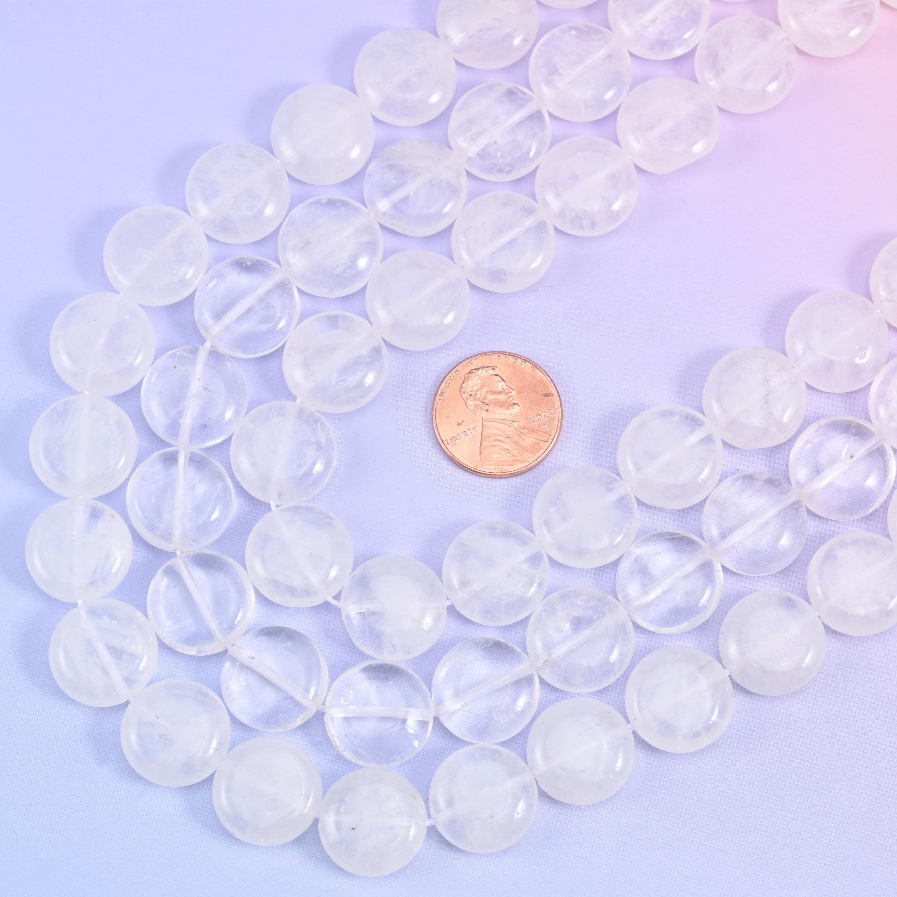 Looped quartz coin strands with a US penny set between them for scale against the 15mm beads