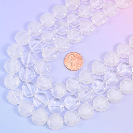 Looped quartz coin strands with a US penny set between them for scale against the 15mm beads