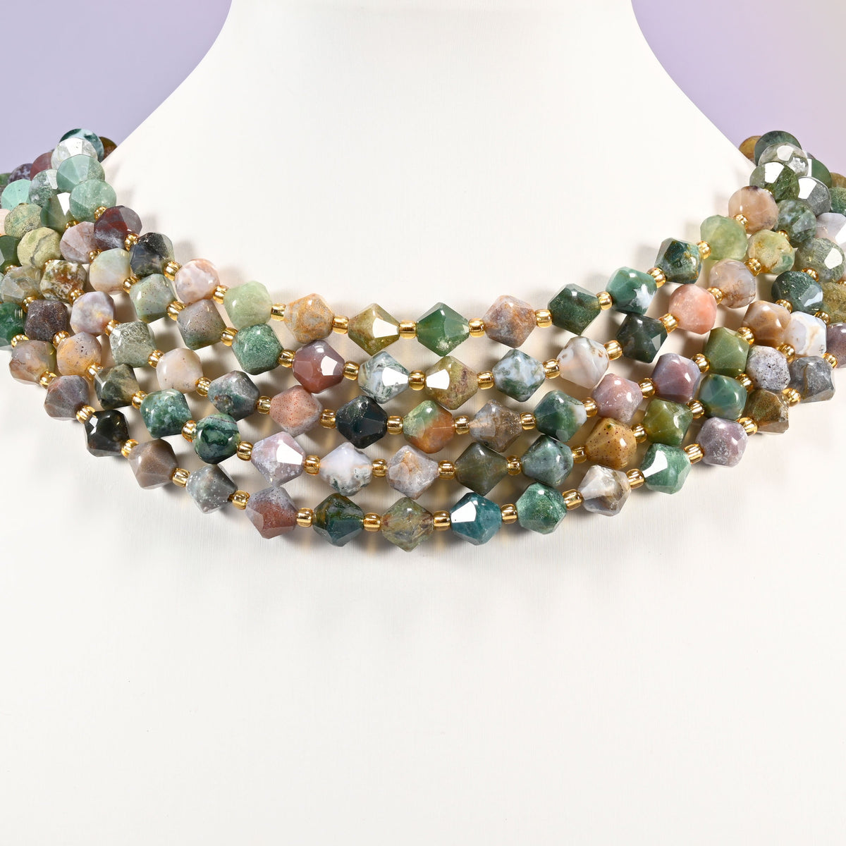 Indian Agate faceted bicone beads 8mm with gold-tone spacers, strand wrapped around a display bust like a choker necklace