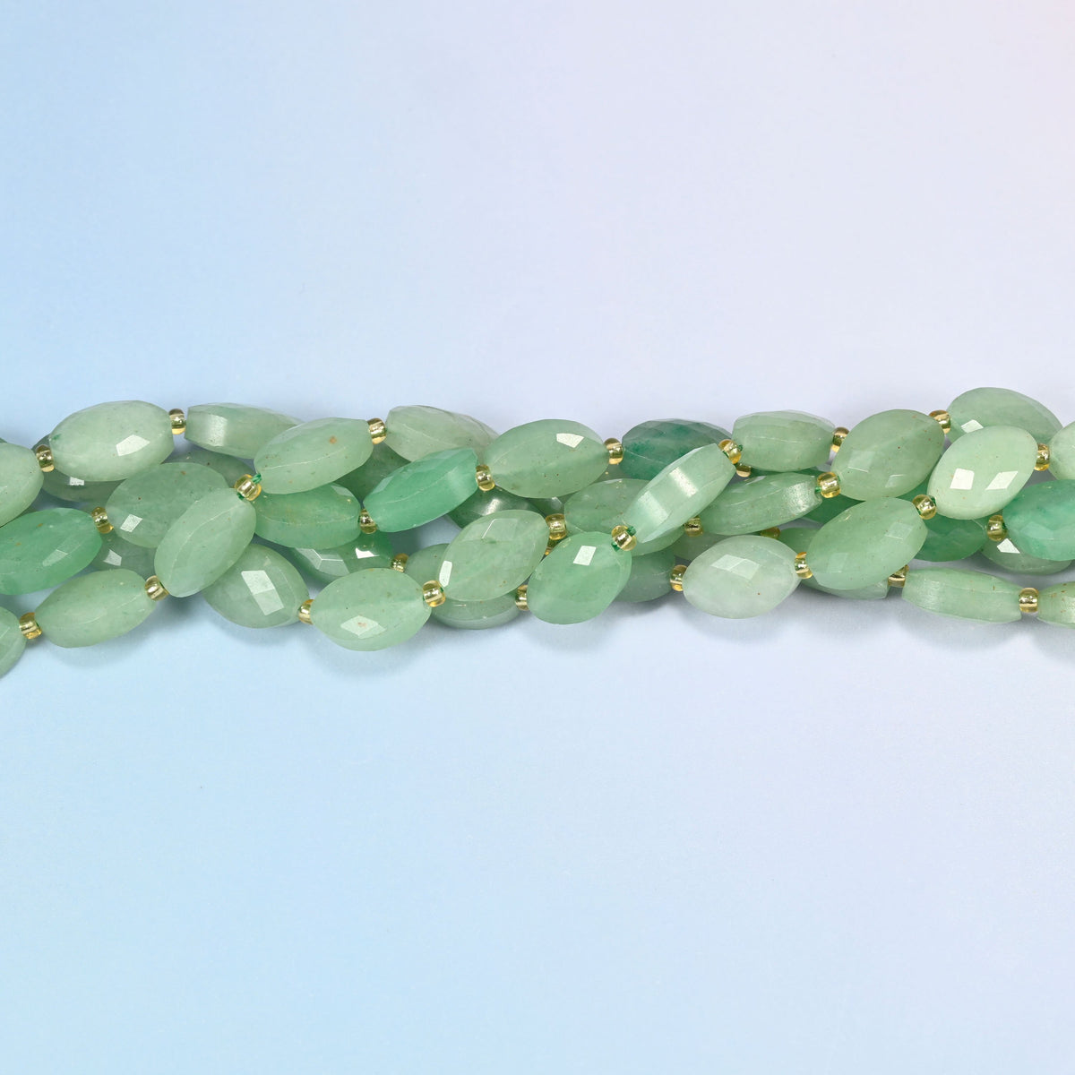 Strands of green aventurine faceted flat oval beads twisted together in a horizontal row