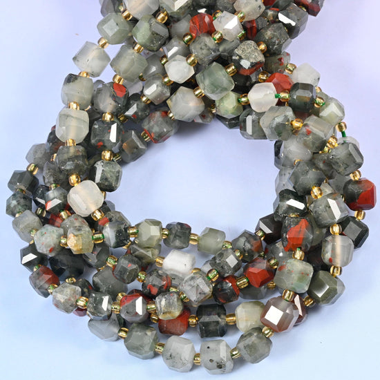 Smoky grey-green cubes, some almost translucent, punctuated along the strand by cubes of brick red and rust — the colour break that gives this stone its name