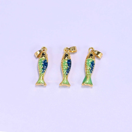 Fish charm in blue and green enamel with a glossy gold tail