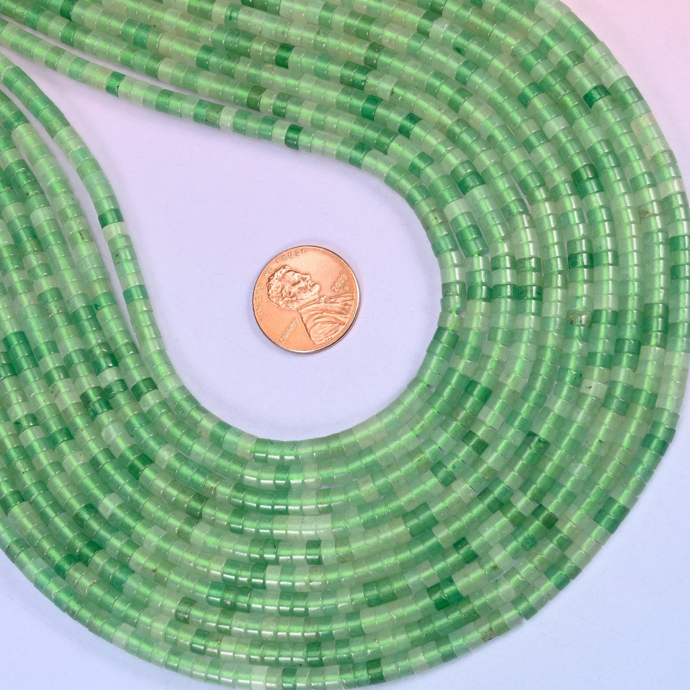 Natural Green Aventurine smooth heishi disc beads in fresh spring green with a soft translucent glow, finished with a polished, sophisticated look.