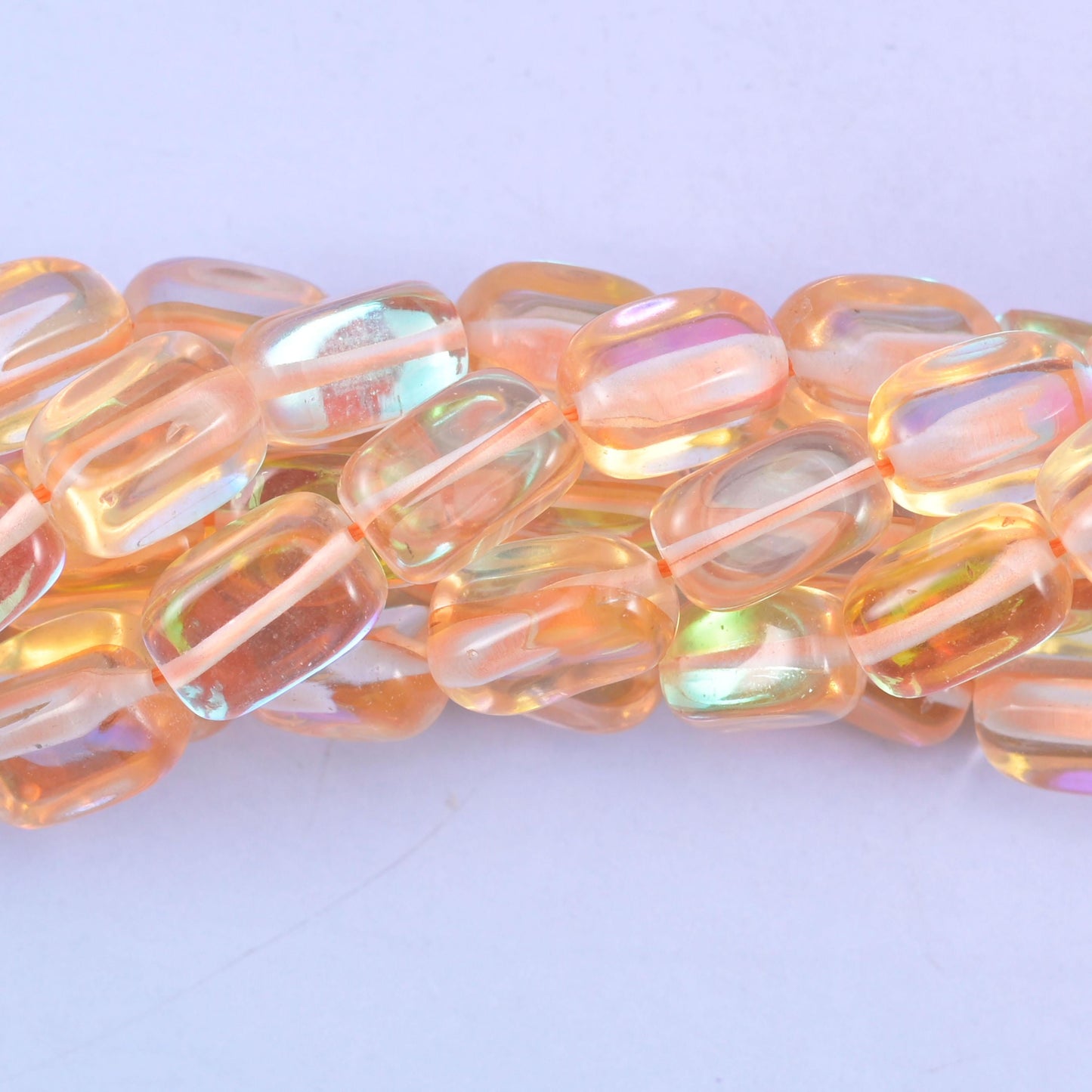 Rectangular cut glass beads with a glossy transparent finish and iridescent mystic aura coating