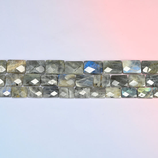 Gray Labradorite faceted flat rectangle beads in horizontal rows, the flat tablet faces sitting edge to edge