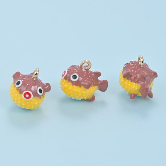 Plump little puffer fish with a raised dotted body and glossy enamel colour