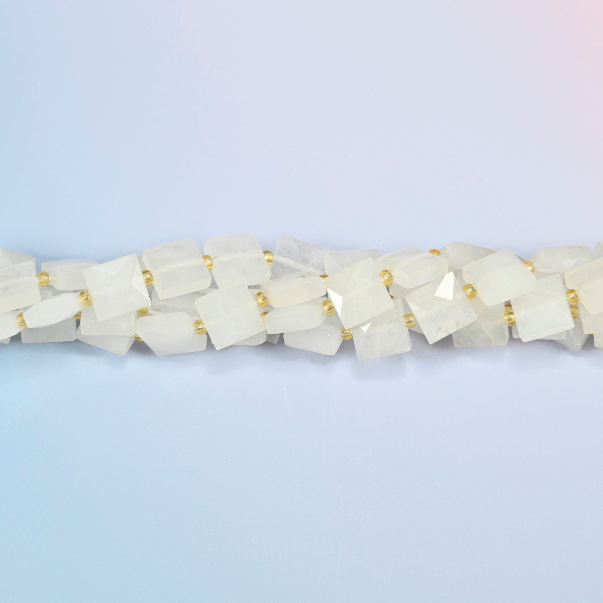 Strands of clear quartz faceted flat square beads twisted together in a horizontal row