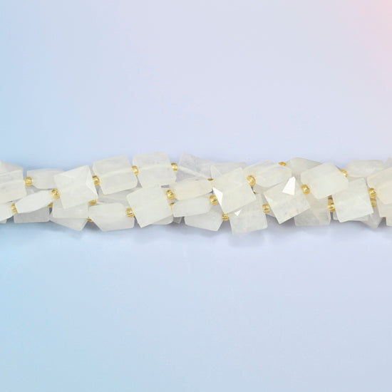 Strands of clear quartz faceted flat square beads twisted together in a horizontal row
