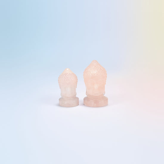 Natural rose quartz Buddha head carvings in light pink, 1.5 inch and 2 inch side by side