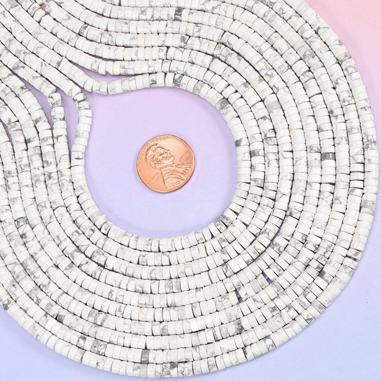 Natural White Howlite smooth heishi disc beads in classic white with characteristic gray veining, finished with a polished, sophisticated look.