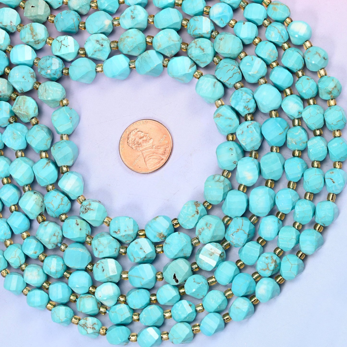 Dyed Light Blue Howlite Faceted Spiral Twist Beads, bright turquoise-blue with the stone's natural grey-brown veining