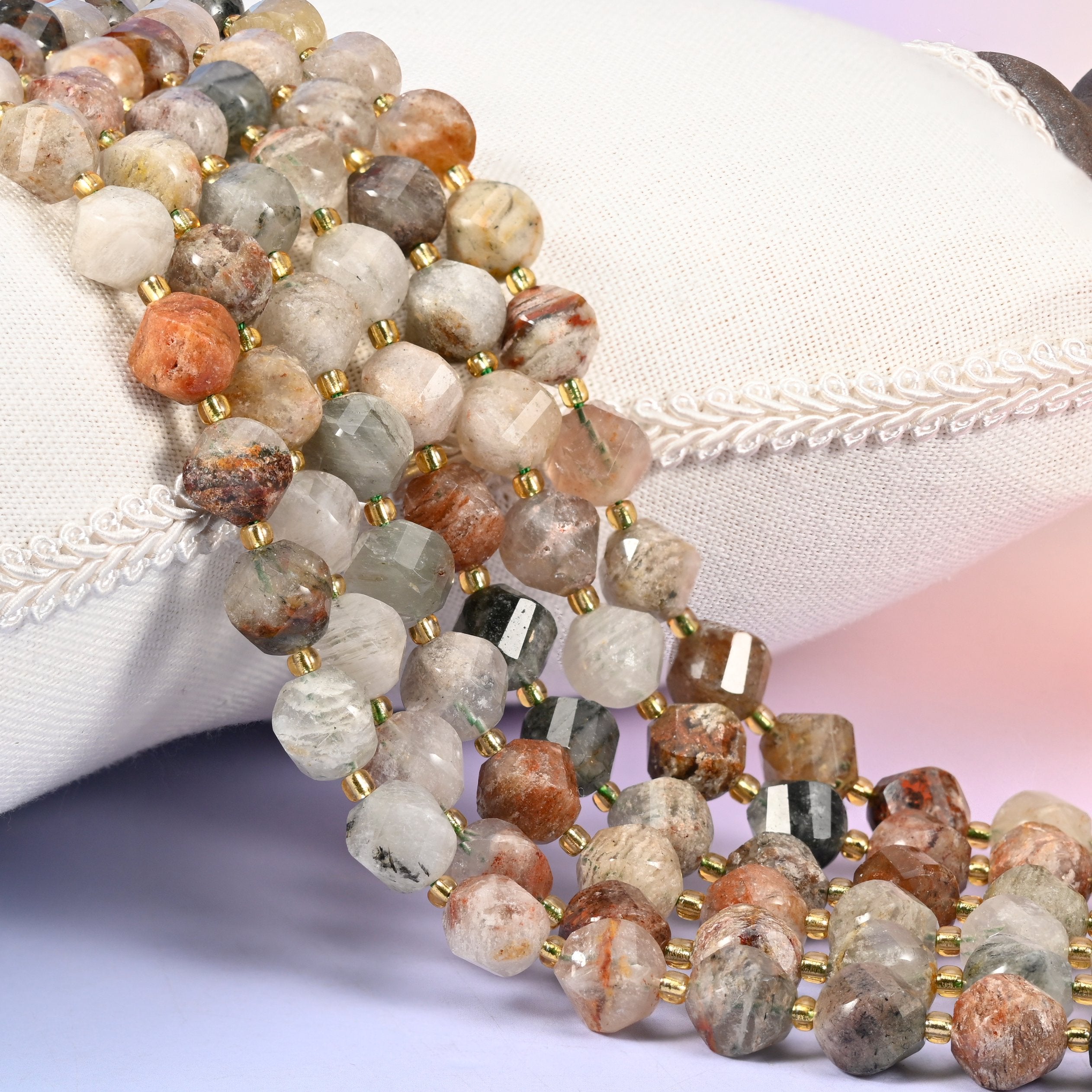 Thousand Layer Phantom Quartz natural crystal beads, 10mm faceted spiral twist, cloudy quartz with layered red-brown, moss green and cream phantoms