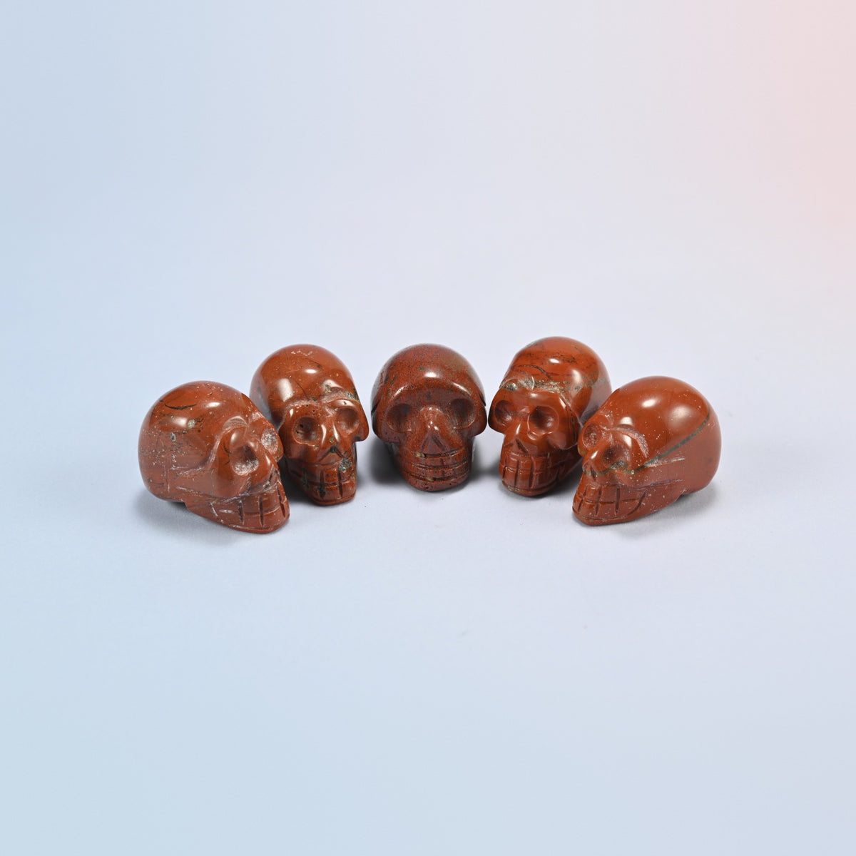 1 inch skull crystal carving in red jasper, brick red natural stone