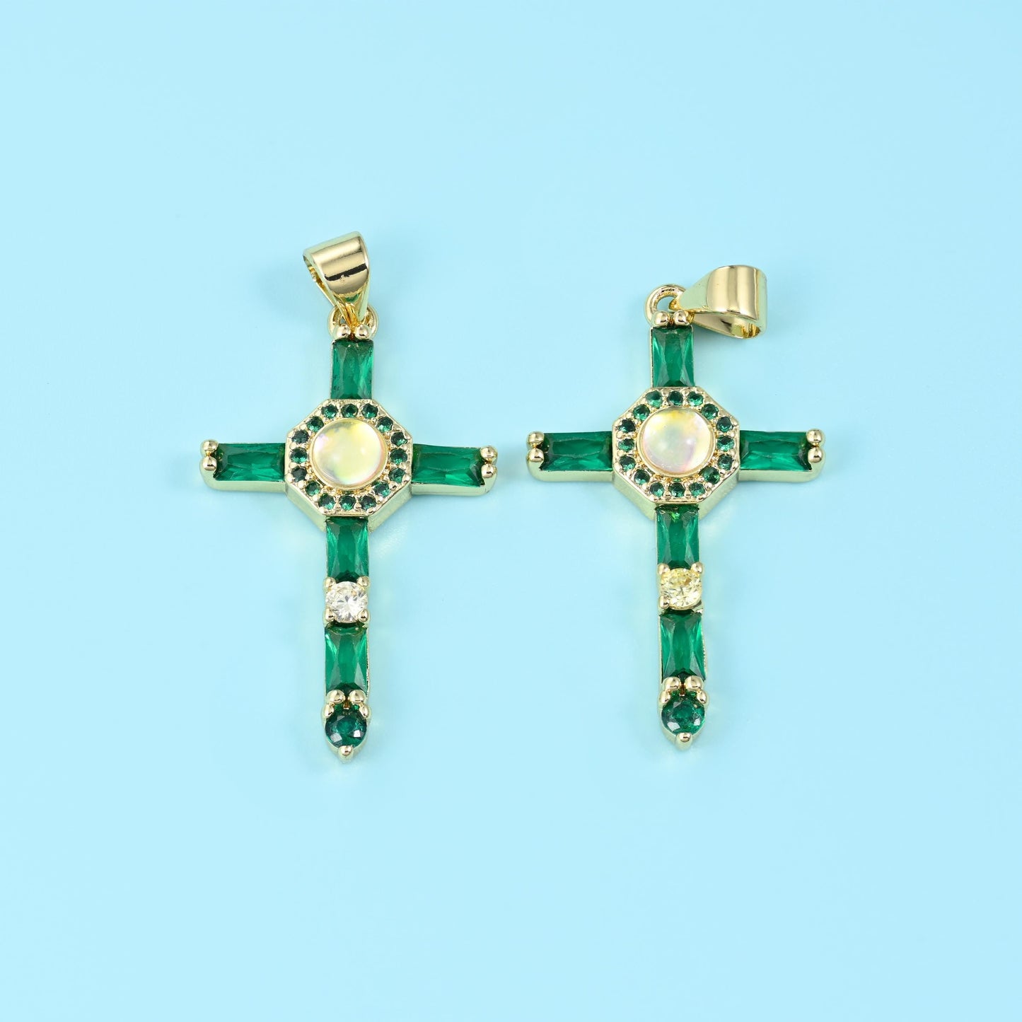 An open gold cross set with long baguette-cut zircon stones down each arm and a small ringed medallion at the centre,…