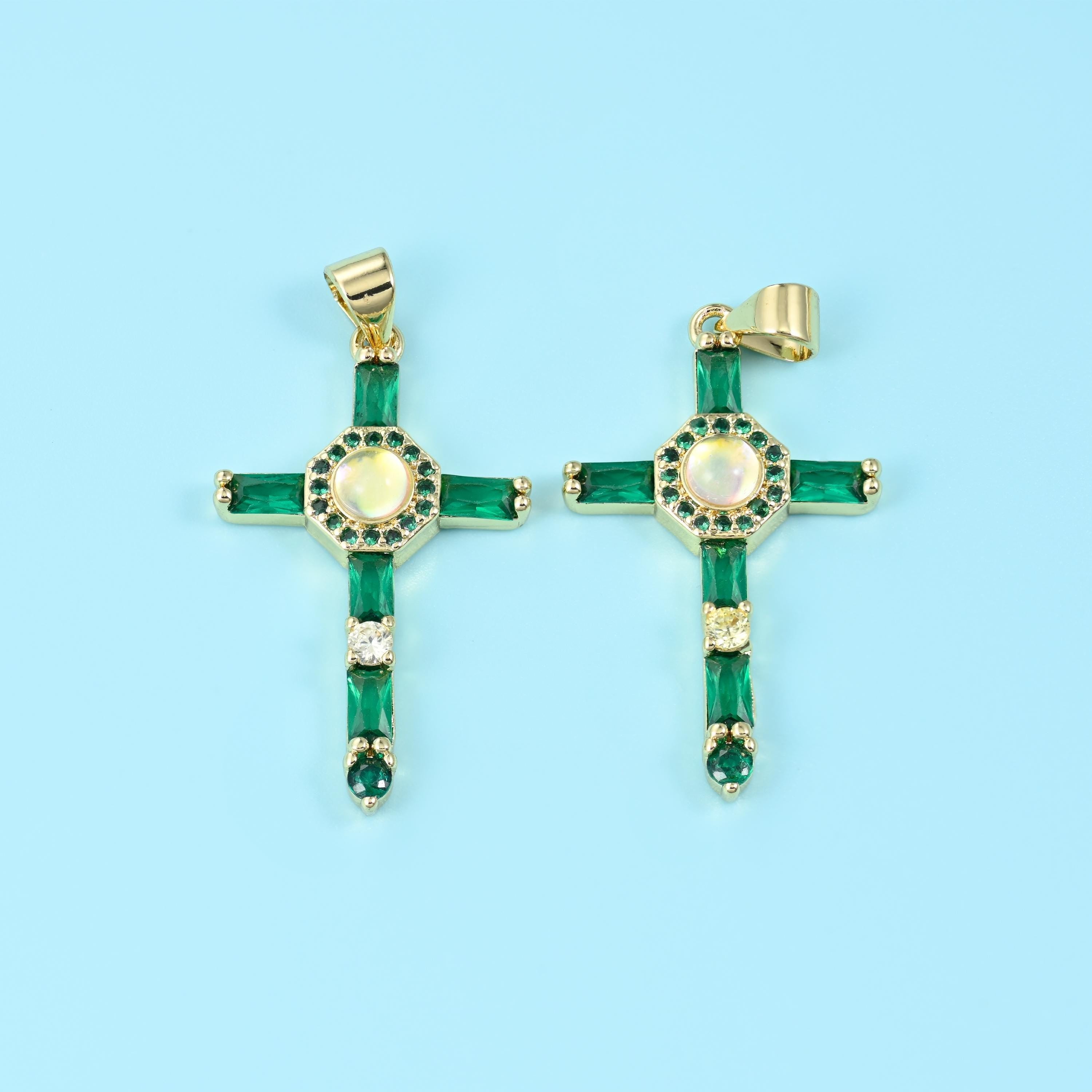 An open gold cross set with long baguette-cut zircon stones down each arm and a small ringed medallion at the centre,…