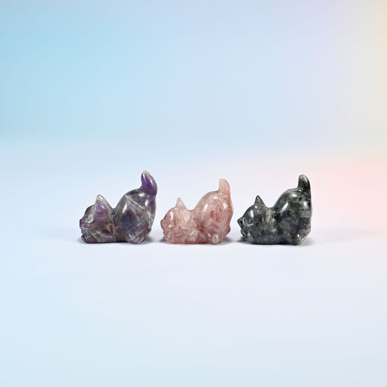 Natural amethyst, strawberry quartz and black labradorite yoga cat carvings seen from the other side, polished smooth all round