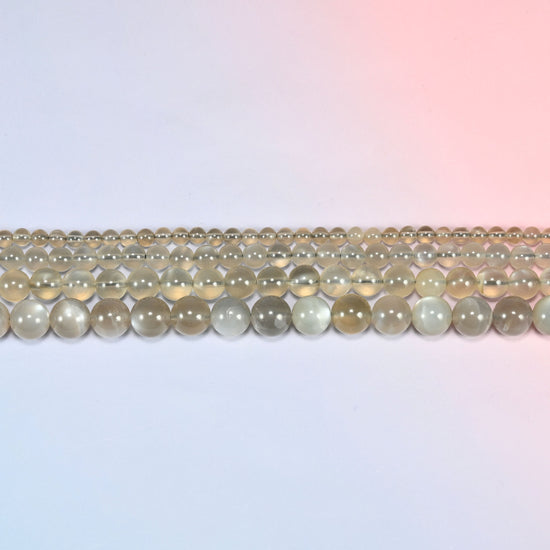 AAA Gray Labradorite smooth round beads in horizontal rows, the bead sizes stepping from small to large