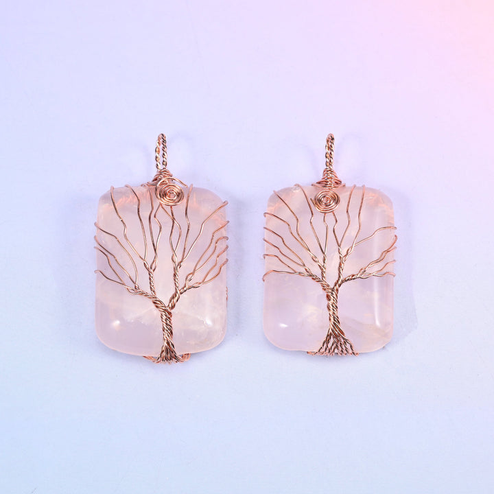 Rectangle Gemstone Tree of Life Pendant in blush pink stone, two pieces side by side with copper wire branches fanned across the polished face.